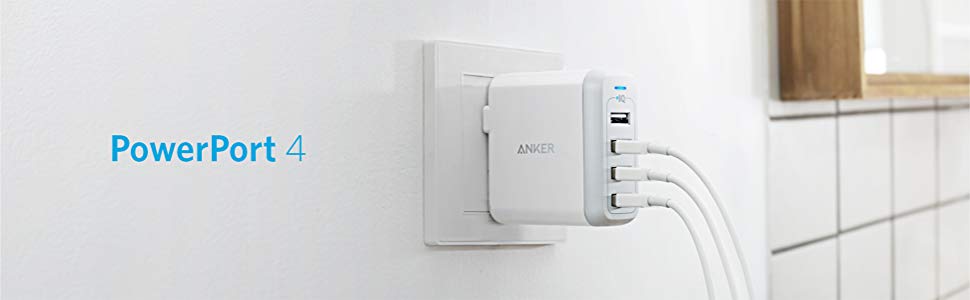 A PowerPort 4 plugged into a wall outlet, with three of the four USB ports connected with USB cables. To the left of the charge are texts reading as “PowerPort 4”.